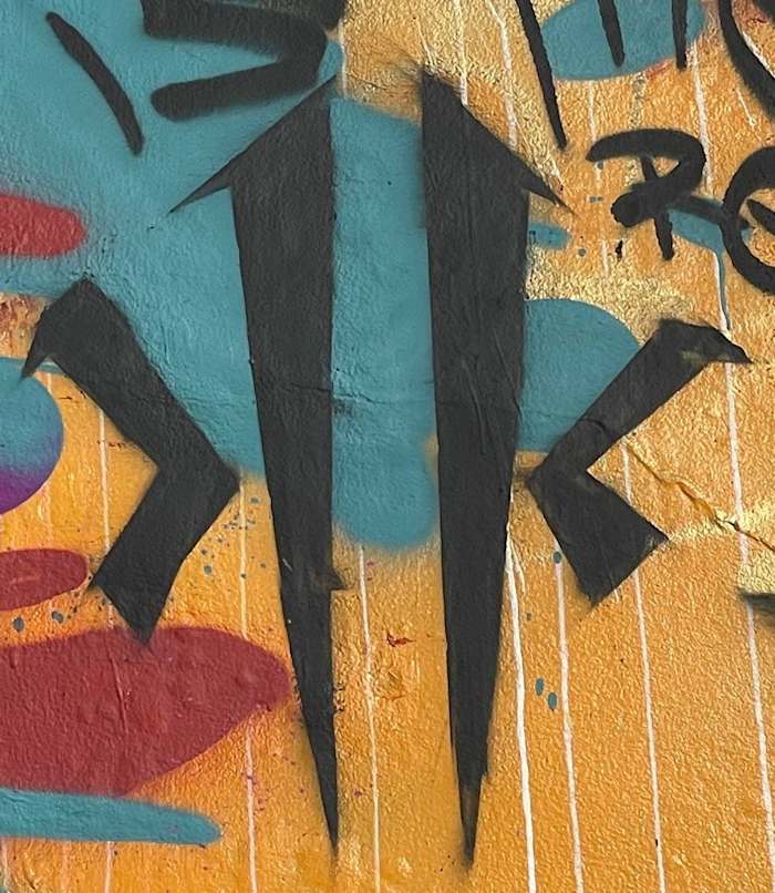 Detailed view of Kyrie Irving's ANTA logo on a mural in China.